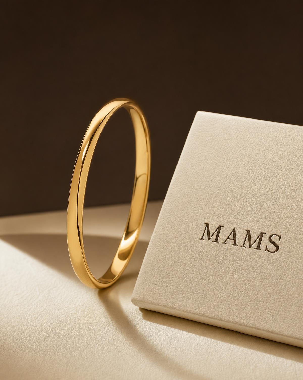 MAMS Aurum Bangle in brushed 21K yellow gold with polished edges, standing upright